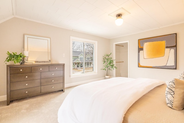 carpeted bedroom featuring vaulted ceiling and baseboards