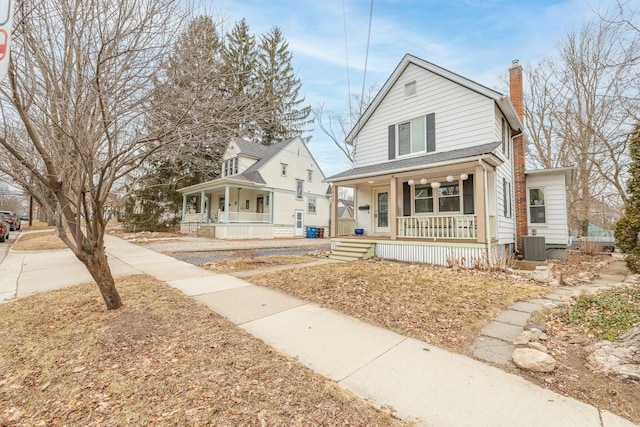 view of front of property featuring a porch, a chimney, and central air condition unit