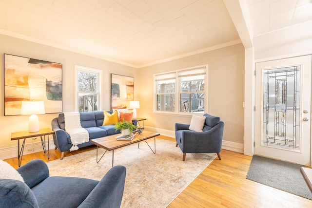 living room featuring baseboards, wood finished floors, a wealth of natural light, and crown molding