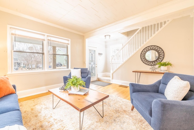 living room with ornamental molding, stairway, baseboards, and wood finished floors