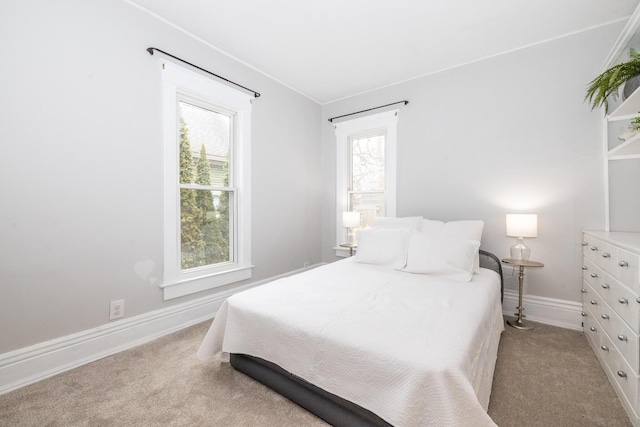 bedroom featuring carpet and baseboards