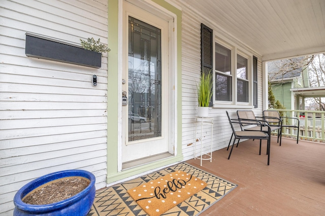 view of exterior entry with a porch