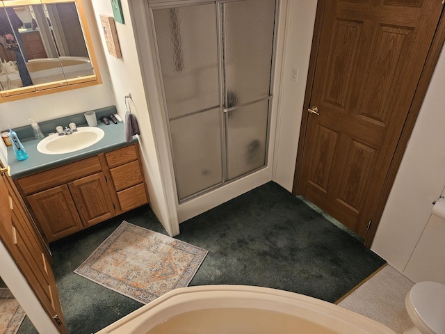 bathroom featuring a stall shower, vanity, and toilet