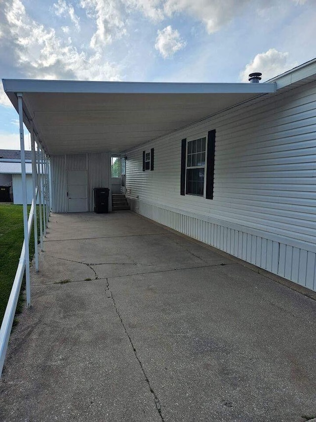 view of vehicle parking with a carport and driveway