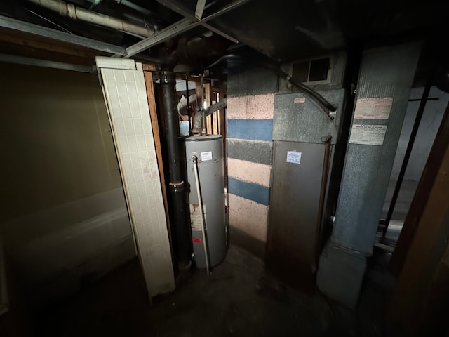 utility room featuring water heater