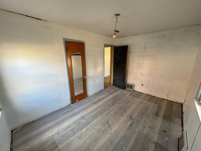 interior space with wood finished floors and visible vents