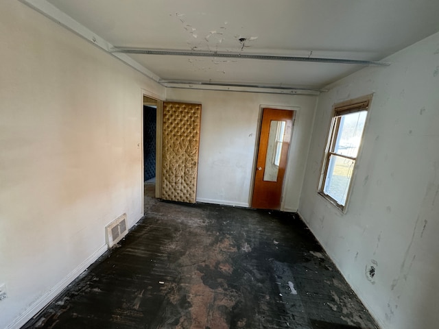 unfurnished room featuring visible vents