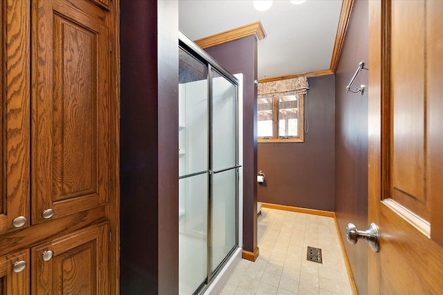 bathroom featuring visible vents, ornamental molding, a shower stall, baseboards, and tile patterned floors