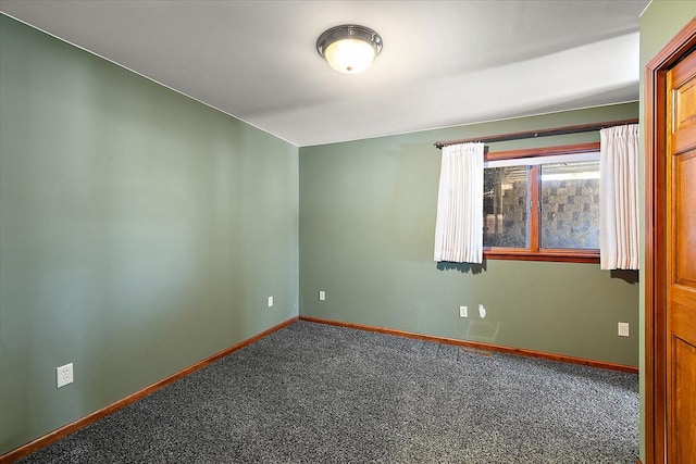 carpeted empty room with baseboards