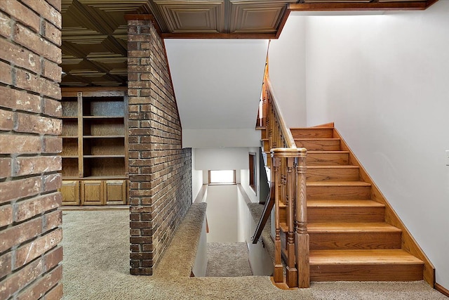 stairway with carpet flooring and a fireplace