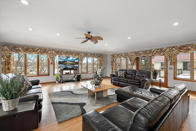 living room with baseboards, ceiling fan, light wood finished floors, and recessed lighting