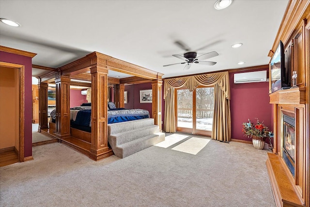 bedroom with access to exterior, crown molding, light colored carpet, a glass covered fireplace, and an AC wall unit