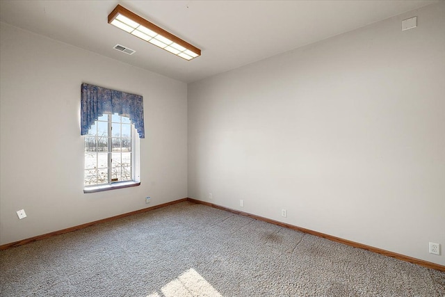 unfurnished room featuring carpet floors, baseboards, visible vents, and vaulted ceiling