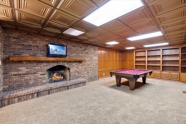 recreation room featuring an ornate ceiling, carpet floors, a fireplace, pool table, and wood walls