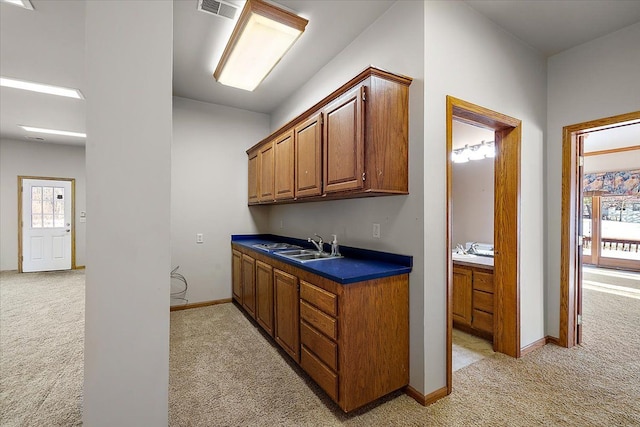 bar with baseboards, a sink, visible vents, and light colored carpet