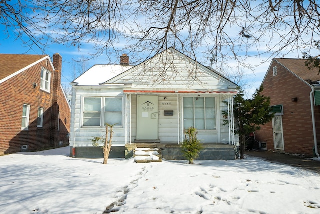 view of front of house featuring a chimney