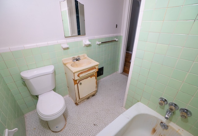 bathroom with toilet, a bathing tub, tile walls, and tile patterned floors