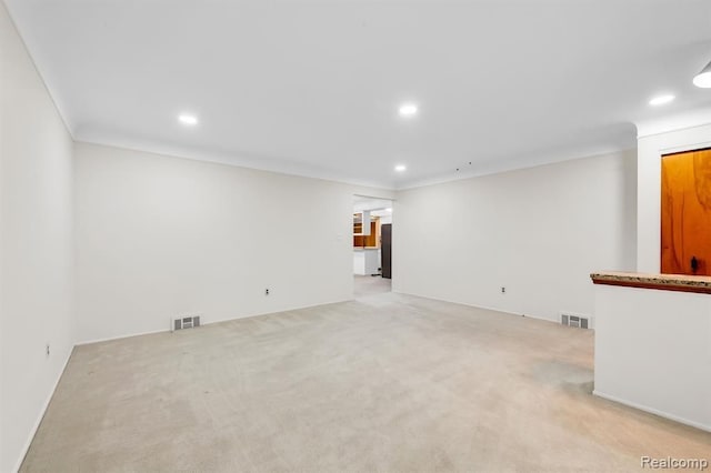 unfurnished living room featuring recessed lighting, visible vents, and light carpet