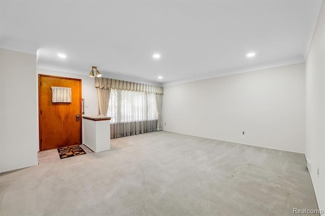 carpeted empty room featuring ornamental molding and recessed lighting