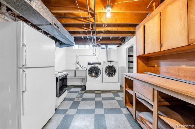 washroom with dark floors, independent washer and dryer, and laundry area