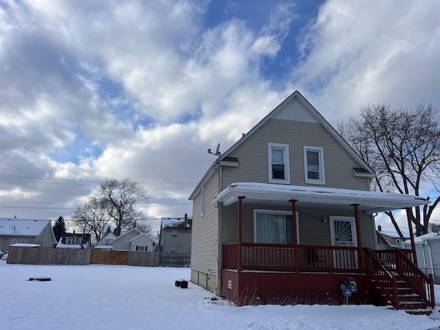 view of front of home with covered porch and fence