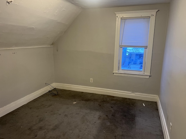 bonus room featuring carpet floors, lofted ceiling, and baseboards