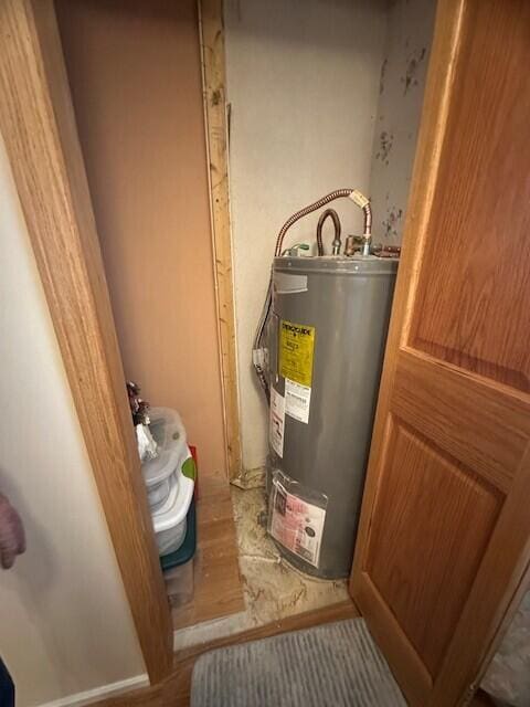 utility room with electric water heater