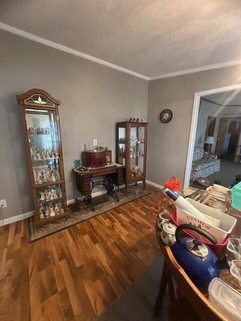 living room with ornamental molding, a textured ceiling, and wood finished floors