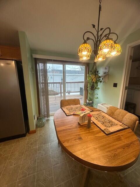 dining space featuring a chandelier and tile patterned floors