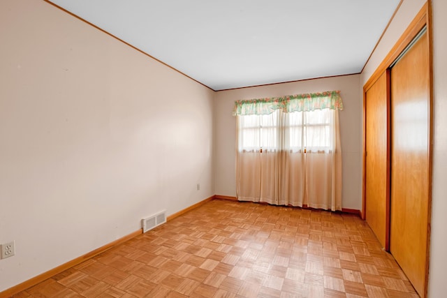 spare room with visible vents and baseboards