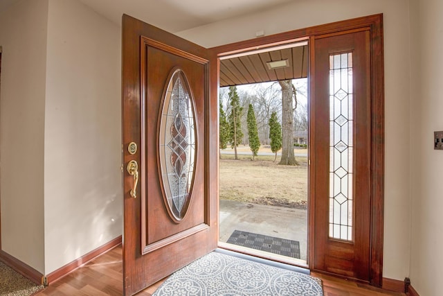 entryway with wood finished floors and baseboards