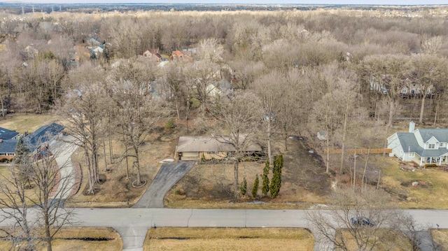 drone / aerial view featuring a wooded view