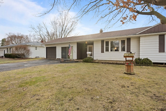 single story home featuring aphalt driveway, a front lawn, an attached garage, and board and batten siding