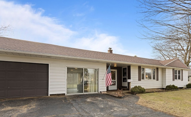 single story home with driveway, a garage, a chimney, and roof with shingles