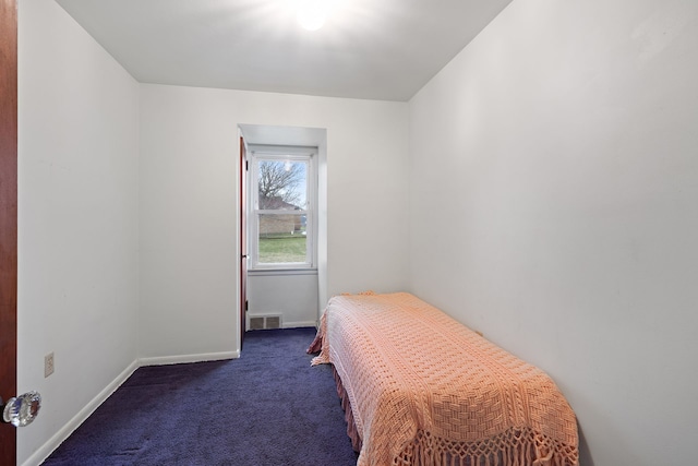 bedroom with baseboards, visible vents, and dark colored carpet