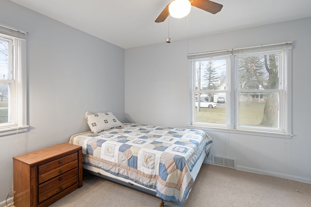 bedroom featuring baseboards, visible vents, ceiling fan, and carpet flooring