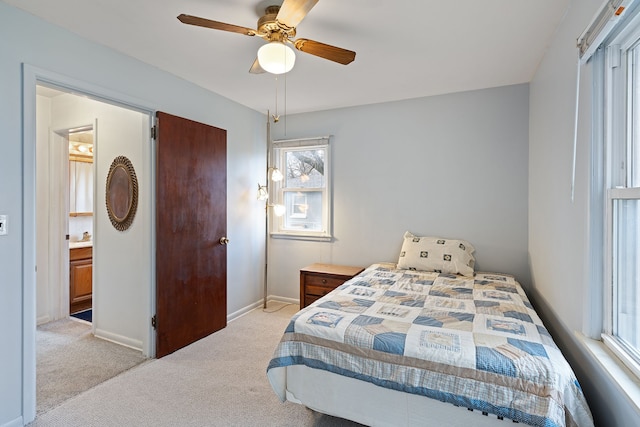 bedroom featuring light carpet, ceiling fan, and baseboards