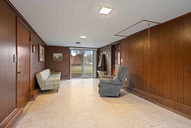 unfurnished room with wooden walls and tile patterned floors