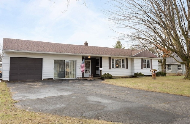 single story home featuring a garage, driveway, roof with shingles, a front lawn, and a chimney