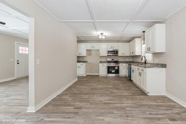 kitchen with light wood-type flooring, appliances with stainless steel finishes, and white cabinets