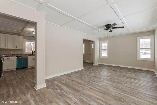 unfurnished room featuring a wealth of natural light, coffered ceiling, baseboards, and wood finished floors