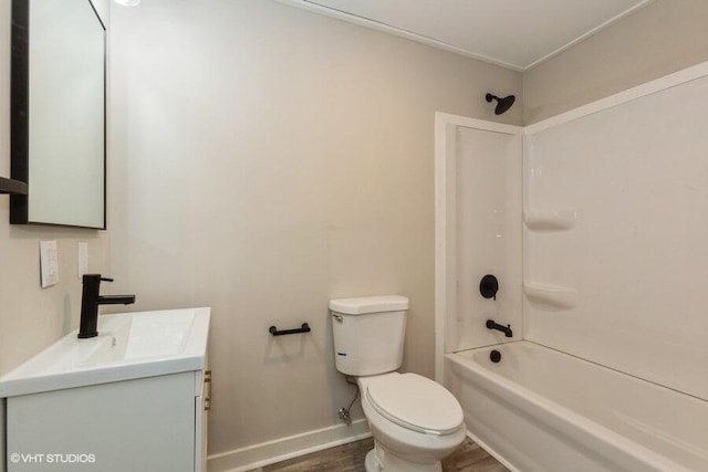 full bathroom with toilet, wood finished floors, bathing tub / shower combination, vanity, and baseboards