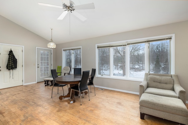 dining room with vaulted ceiling, light wood-style flooring, baseboards, and ceiling fan