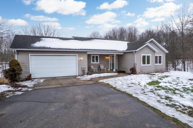 ranch-style house with a garage, driveway, roof with shingles, and covered porch