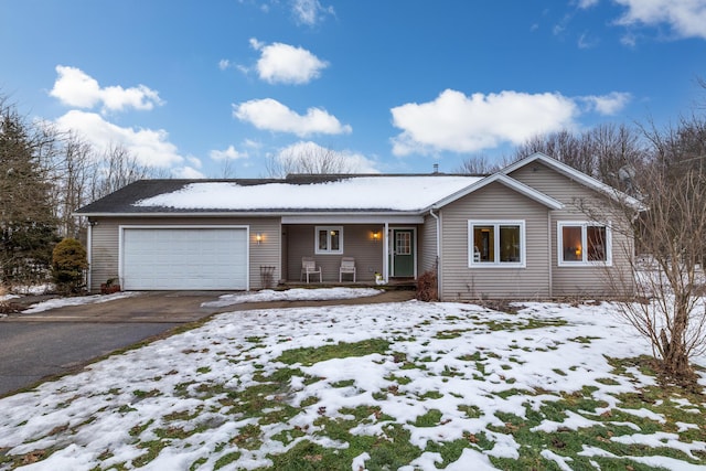 ranch-style house featuring aphalt driveway and a garage