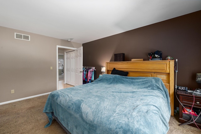 bedroom with baseboards, visible vents, and light colored carpet