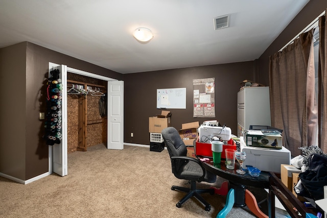 office area with light carpet, baseboards, and visible vents