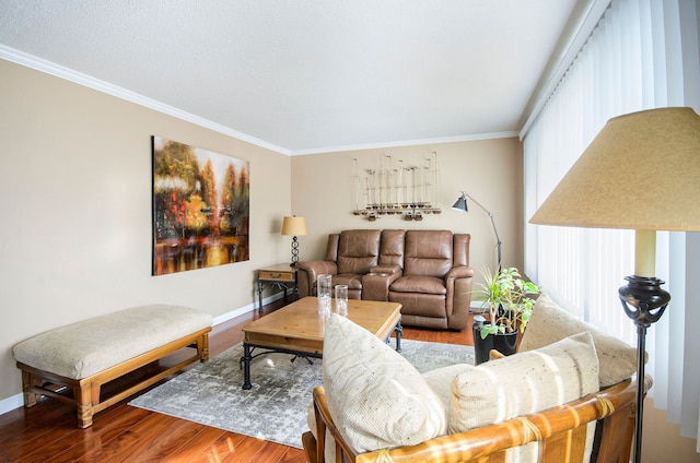 living area featuring crown molding, wood finished floors, and baseboards