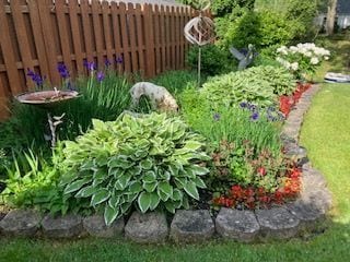 view of yard with a garden and fence