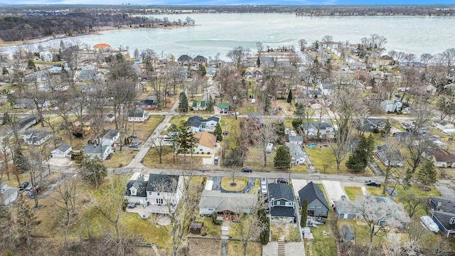 drone / aerial view featuring a water view and a residential view